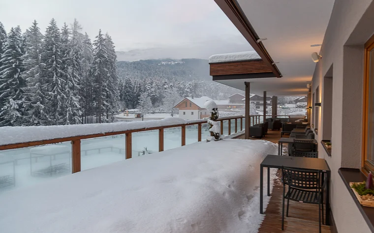 Absolutely stunning impressions Balcony covered in snow with view of snowy trees and houses in winter