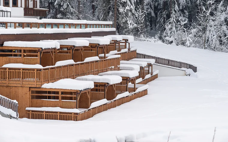 Absolutely stunning impressions Snow-covered wooden balconies and terraces in front of a building in winter