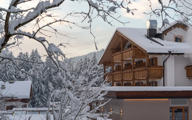 Absolutely stunning impressions Snow-covered hotel with wooden balconies in a winter forest setting