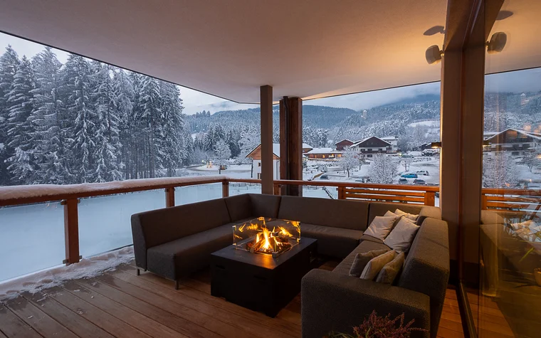 Absolutely stunning impressions Cozy terrace with sofa and fire pit overlooking snowy mountain landscape