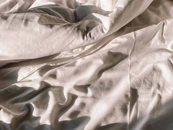 Green Lake Hotel Weiher: 4-star superior hotel in Val Pusteria White crumpled bedsheet with sunlight and shadows
